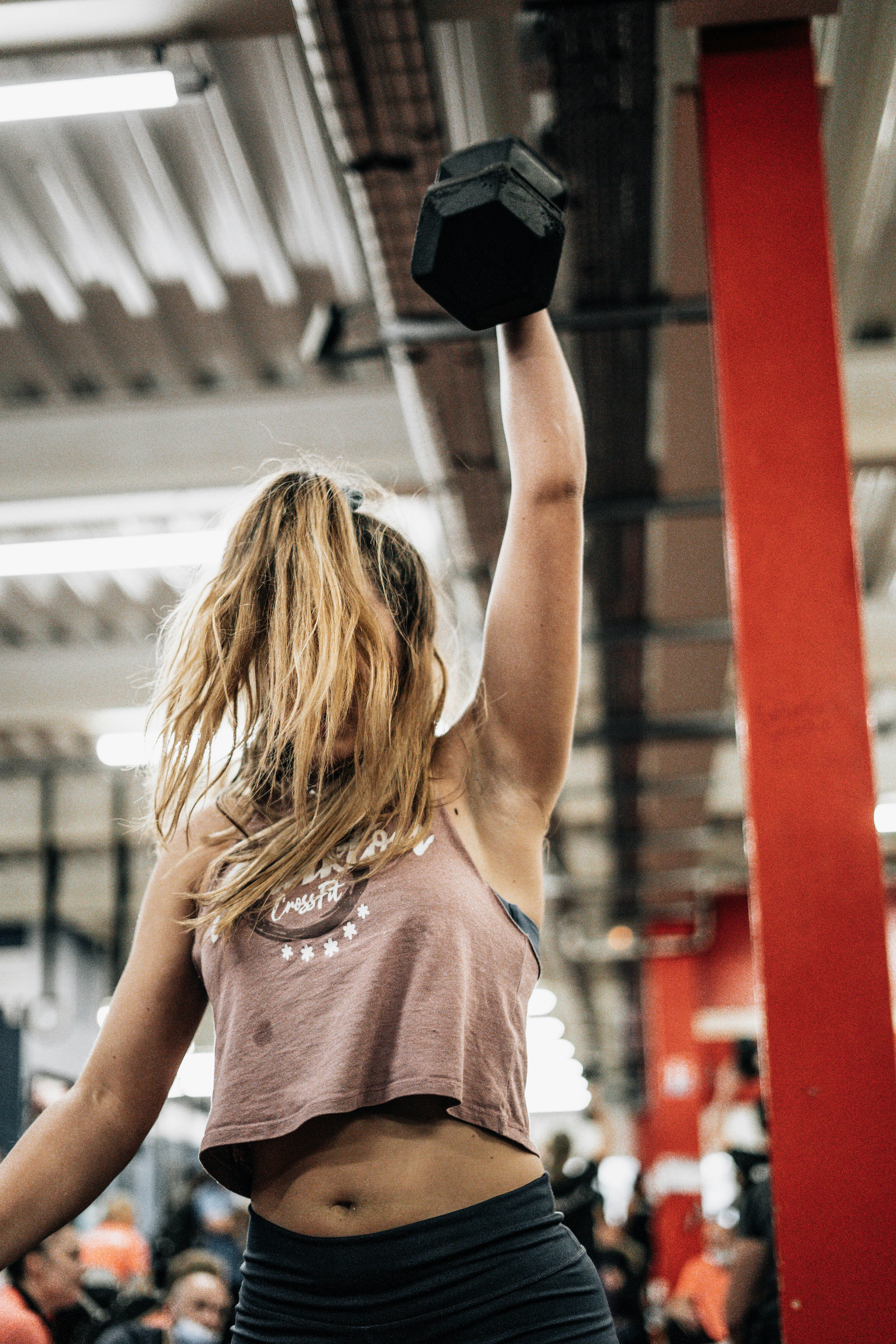 Athlete lifting dumbbell overhead